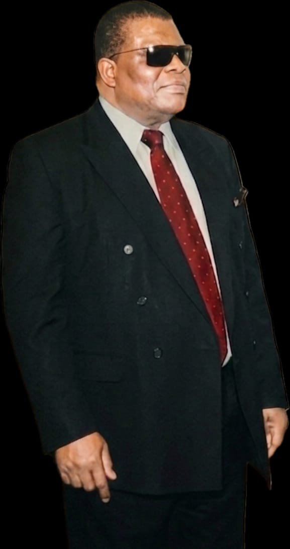 In a dark suit and red tie